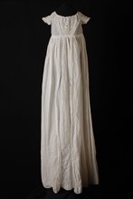 Long flared christening dress in white cotton, V-shaped front, shoulders and bottom of the skirt with very fine French