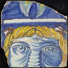 Tile of chimney pilaster, blue, yellow, brown on white, three-quarter head with strands of yellow hair and brown horns, white