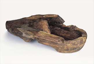 Late 13th century clog for left foot, clog shoe footwear clothing soil find wood, Alder wooden shoe deformed by staying in alder