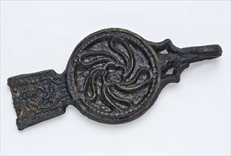 Pewter tongue, belt hook with twisted leaf motif on the disk and hook in shape of male figure, belt clothing accessory clothing