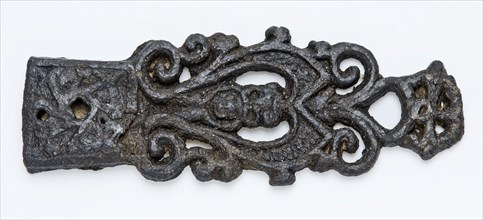 Pewter tongue with lion head and openwork curls, fitting belt clothing accessory clothing soil find tin metal, archeology