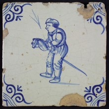 Scene tile, child's play, boy riding on hobbyhorse, corner filler ox head, wall tile tile material ceramics pottery glaze tin
