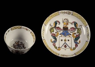 White cup and saucer with multi-colored painting, coat of arms, leaf and flower decoration, cup and saucer drinking utensils