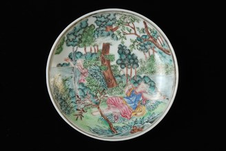 Dish of cup and saucer with lying woman and man in landscape in bushes, cup and saucer drinking utensils tableware holder