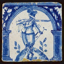 Figure tile, blue on white, warrior with rifle on the shoulder, wall tile tile sculpture ceramic earthenware glaze, baked 2x