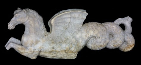 Part of gray-white relief, winged horse with fish tail, Hippocampus, embossed marble stone, fireplace Hippocampus