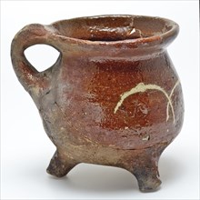 Small pottery cooking jug on three legs, sausage ear, decorated with yellow bows in sludge technology, grape cooking pot