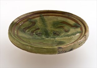 Small earthenware plate on small stand, decorated with brown and green decor on yellow background, plate dish crockery holder