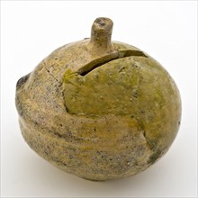 Fragment of piggy bank, yellow, ball with coin slot, money box holder soil find ceramic earthenware glaze lead glaze, hand