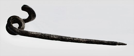 Needle of fibula or mantle pin, fibula fastener soil find bronze metal, cast drawn bronze needle of fibula. Curled feather
