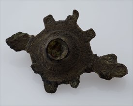 Bronze fibula or mantelpiece in the form of toothed circle with small enamel button, fibula fastener soil find bronze metal