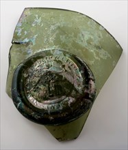 Fragment of the abdominal bottle on which seal with Bacchus on the barrel and round, belly bottle bottle holder soil find glass