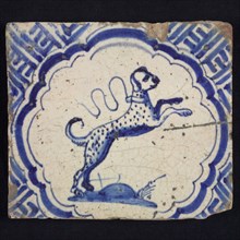 Animal tile with dog in scalloped frame, blue decor on white background, corner filling with meanders, wall tile tile sculpture