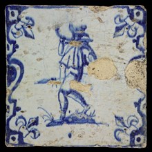 Figure tile, float or soldier with horn and spear, blue decor on white ground, baluster with French lilies, marked, wall tile
