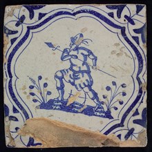 KK, Figure tile with soldier, blue decor on white ground, accolade picture frame and volutes, marked, wall tile tile sculpture