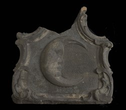 Fragment of facing brick, half moon with human face in frame, facing brick fragment sculpture sculpture building component