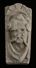 Keystone with gable head, left looking man, keystone gable ornament building limestone stone, sculpted Above wider than under