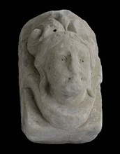 Console with woman's head, on top of double curl, console building element sandstone stone, sculpted