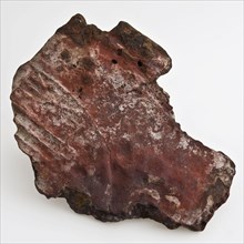 Fragment of an iron hob or stove, fireback soil found iron metal, cast Flat piece of metal. Irregular in shape. Surface provided