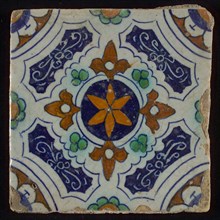 Tile, blue, green, brown and orange on white, central an orange star in circle, sgraffito surfaces, corner motif quarter rosette
