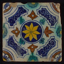 Tile, blue, green, brown and yellow on white, central yellow star in circle, sgraffito surfaces, corner motif, quarter rosette
