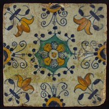 Tile, blue draft, yellow, green and orange on white, centrally flower within star shape, three-spot around, half rosette, corner