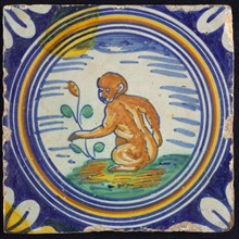 Animal tile, blue, brown, green and yellow on white ground, inside circle sitting monkey and plant, quarter rosette, wall tile