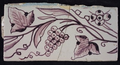 Rectangular edge tile in purple with hinged decor of flower, leaves and bunch of grapes, called grape half, edge tile wall tile