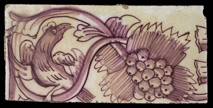 Rectangular edge tile in purple with serpentine decor of leafy tendril, twisted bird to the right, grape bunch, border tile wall
