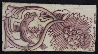 Rectangular edge tile in purple with serpentine decor of leafy tendril, bird to the right, bunch of grapes, border tile wall