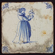 Scene tile, child's play, child with windmill, corner motif ox's head, wall tile tile sculpture ceramic earthenware glaze, baked