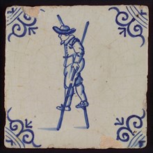 Scene tile, child's play, child with stilts, corner motif ox's head, wall tile tile sculpture ceramic earthenware glaze tin