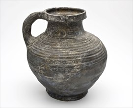 Jug of dark gray earthenware with cuff collar around neck and rings on the shoulder, jug crockery holder soil find ceramic