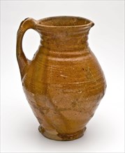 Reddish-brown pottery jug clipped with skin clip and top of the ear, jug crockery holder soil find ceramic earthenware glaze