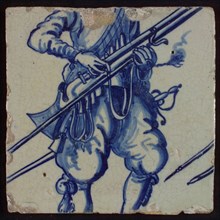 Tile of tableau with in blue torso of soldier with rifle, tile picture footage fragment ceramic pottery glaze, baked 2x glazed