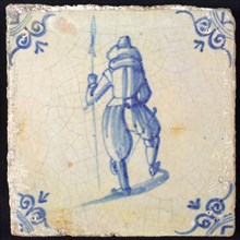 White tile with blue warrior with spear, seen from behind; corner pattern ox head, wall tile tile sculpture ceramic earthenware