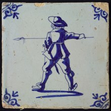 White tile with blue warrior with spear, seen from behind; corner pattern ox head, wall tile tile sculpture ceramics pottery