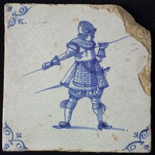 White tile with blue warrior with spear and helmet; corner pattern ox head, wall tile tile sculpture ceramic earthenware glaze