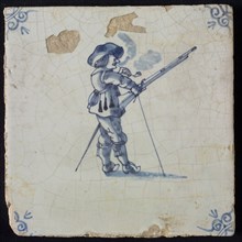 Tile with warrior with musket in standard and pipe-smashing, corner motif of ox-head, wall tile tile sculpture ceramic