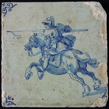 White tile with blue horseman in armor with lance; corner pattern ox head, wall tile tile sculpture ceramic earthenware glaze