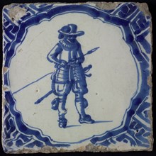 White tile with blue warrior in brace-shaped frame, corner pattern meander, wall tile tile sculpture ceramic earthenware glaze