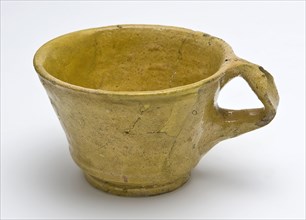 Yellow head with ear, tapered form, constriction above the foot, cup crockery holder soil find ceramic earthenware glaze lead