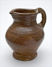 Red pottery jug with convex belly, ear and shank, rings around the neck, jug holder soil find ceramic earthenware glaze lead