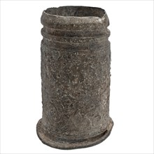 Tin case or cup with decoration of grotesque, candle cup?, tube holder soil find tin metal, cast Tin candle cup with vines