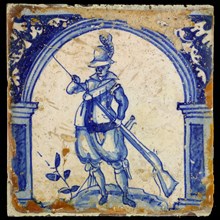 Figure tile, in blue on white, warrior with rifle, wall tile tile sculpture ceramics pottery glaze, baked 2x glazed painted