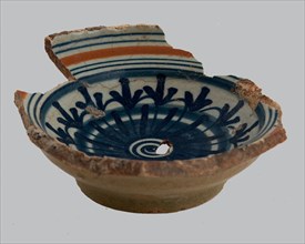 Fragment of majolica salt scale, rosette in the mirror, along the flag lines in orange and blue, salt barrel tableware holder