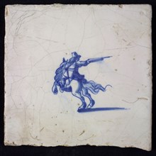 White tile with blue rider with rifle, wall tile tile sculpture ceramic earthenware glaze, baked 2x glazed painted