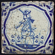 White tile with blue warrior in brace-shaped frame, corner motif wing leaf, wall tile tile sculpture ceramic earthenware glaze