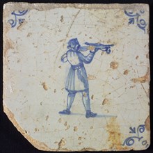 White tile with blue warrior shooting with crossbow; corner pattern ox head, wall tile tile sculpture ceramics pottery glaze