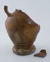 Fragments of stoneware jug on pinched foot with salt glaze, jug crockery holder soil find ceramic stoneware glaze salt glaze